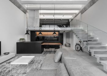 A Modern Loft Interior with a Monochrome and Wood Material Palette in Kaunas, Lithuania.