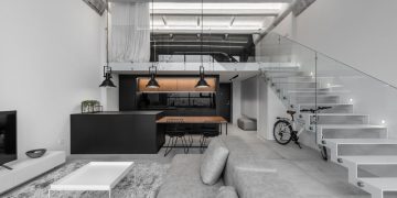 A Modern Loft Interior with a Monochrome and Wood Material Palette in Kaunas, Lithuania.