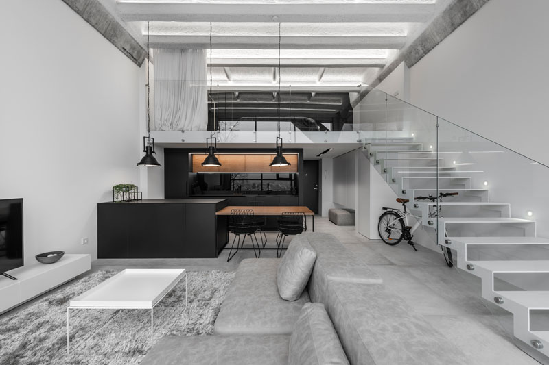 A Modern Loft Interior with a Monochrome and Wood Material Palette in Kaunas, Lithuania.